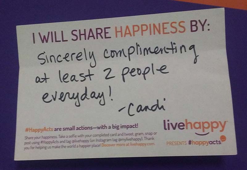 A picture of Candi's note explaining how she will share happiness. It says: I will share happiness by sincerely complimenting at least 2 people everyday!