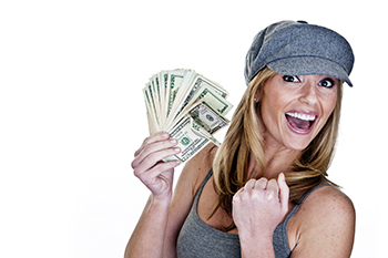 Smiling woman holding up a handful of cash.