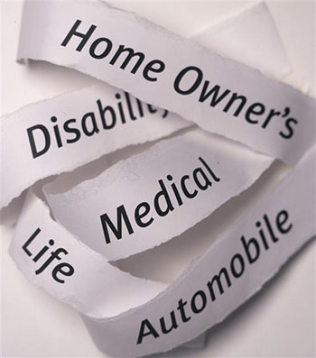 Shreds of paper printed with types of insurance: home owner's, disability, medical, life, automobile.
