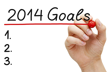 Hand underlining 2014 Goals with red marker isolated on white.