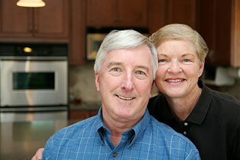 Senior couple together in their kitchen.